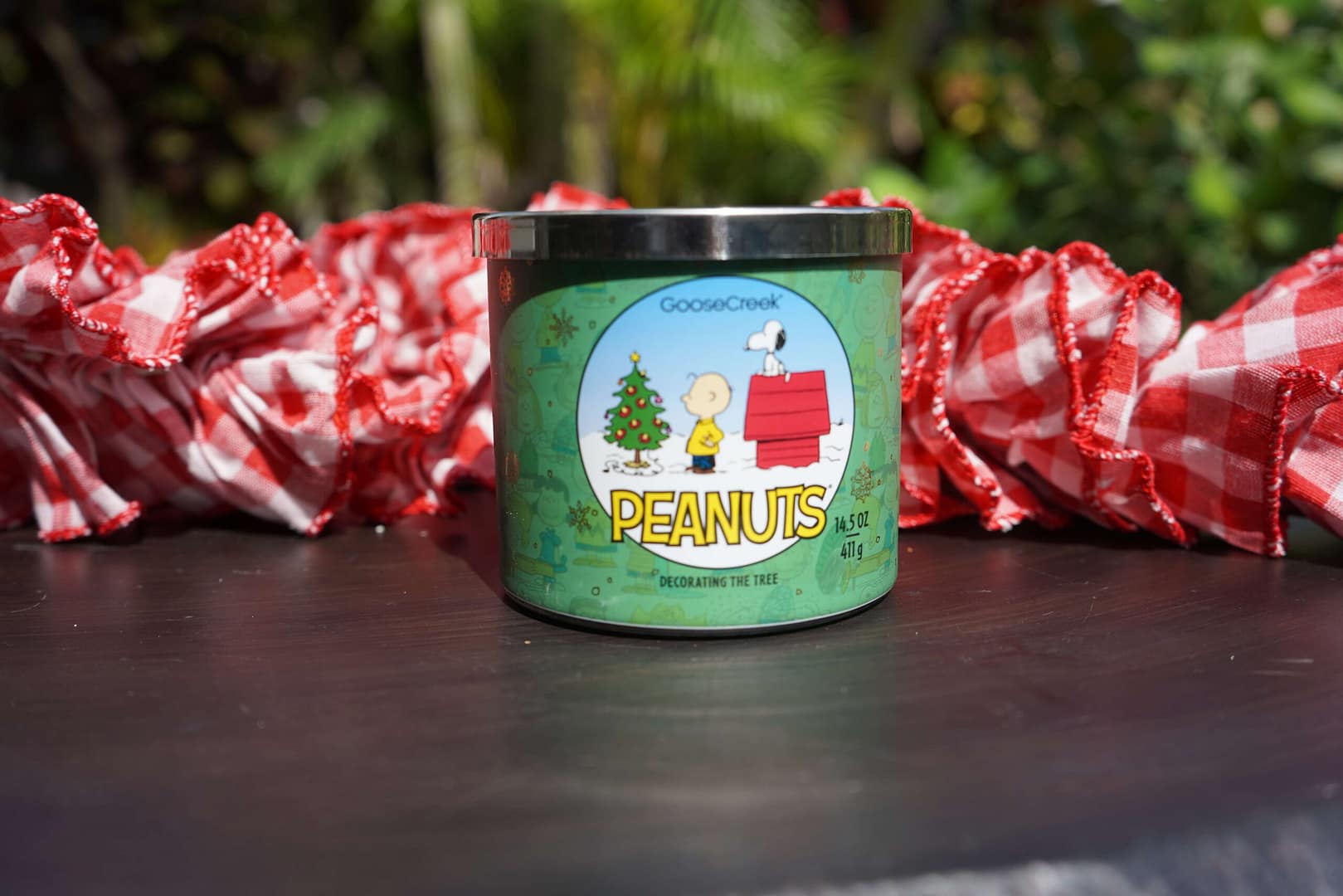 Goose Creek Christmas Candle Sitting on a Table Outside