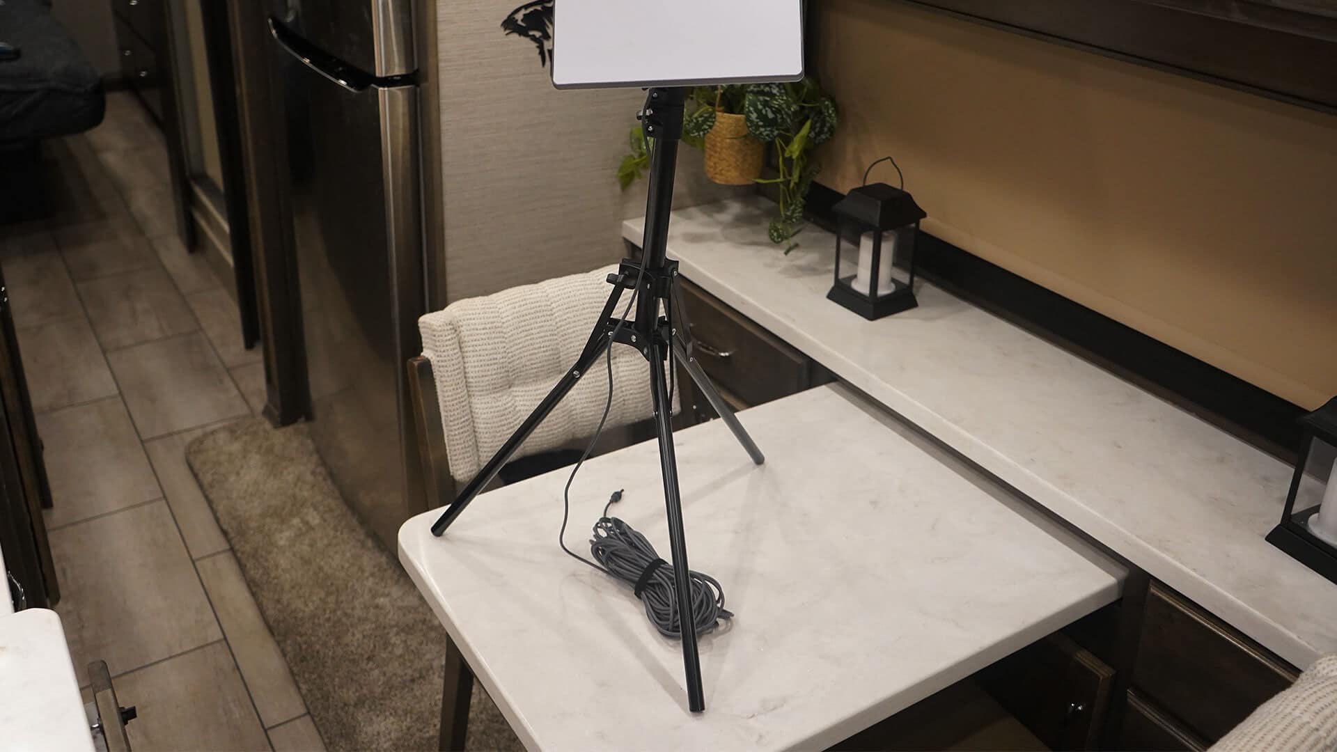 Starlink Mini mounted on a travel tripod inside an RV