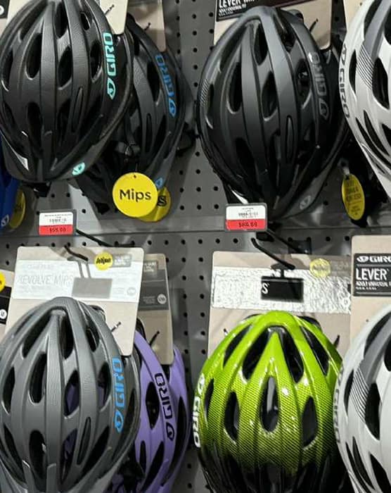 Helmets on store rack showing Mips logo