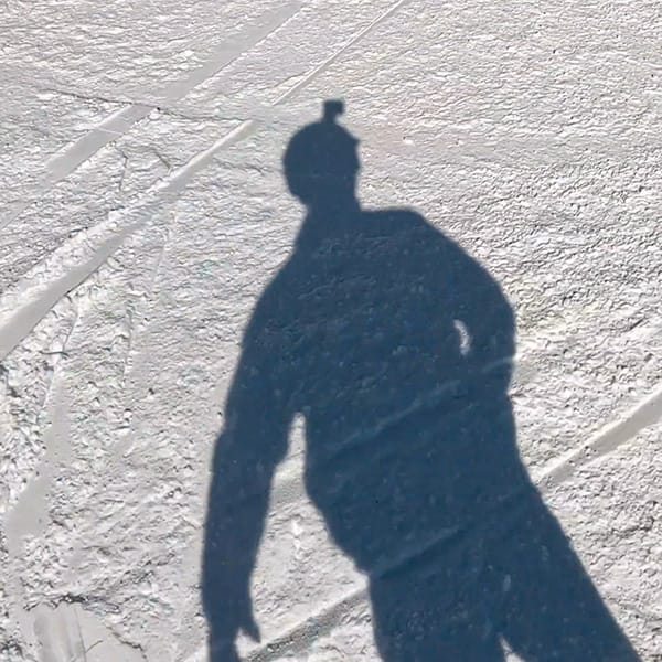 Snowboarder shadow with GoPro on helmet