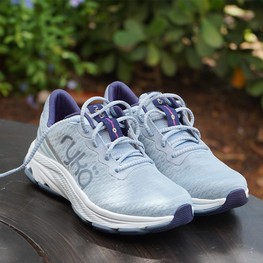 Pair of Ryka Devotion X Max RS Walking Shoes in Ashley Blue, including the fabric textures, outsole design, arch support, and other details that stand out in natural light.